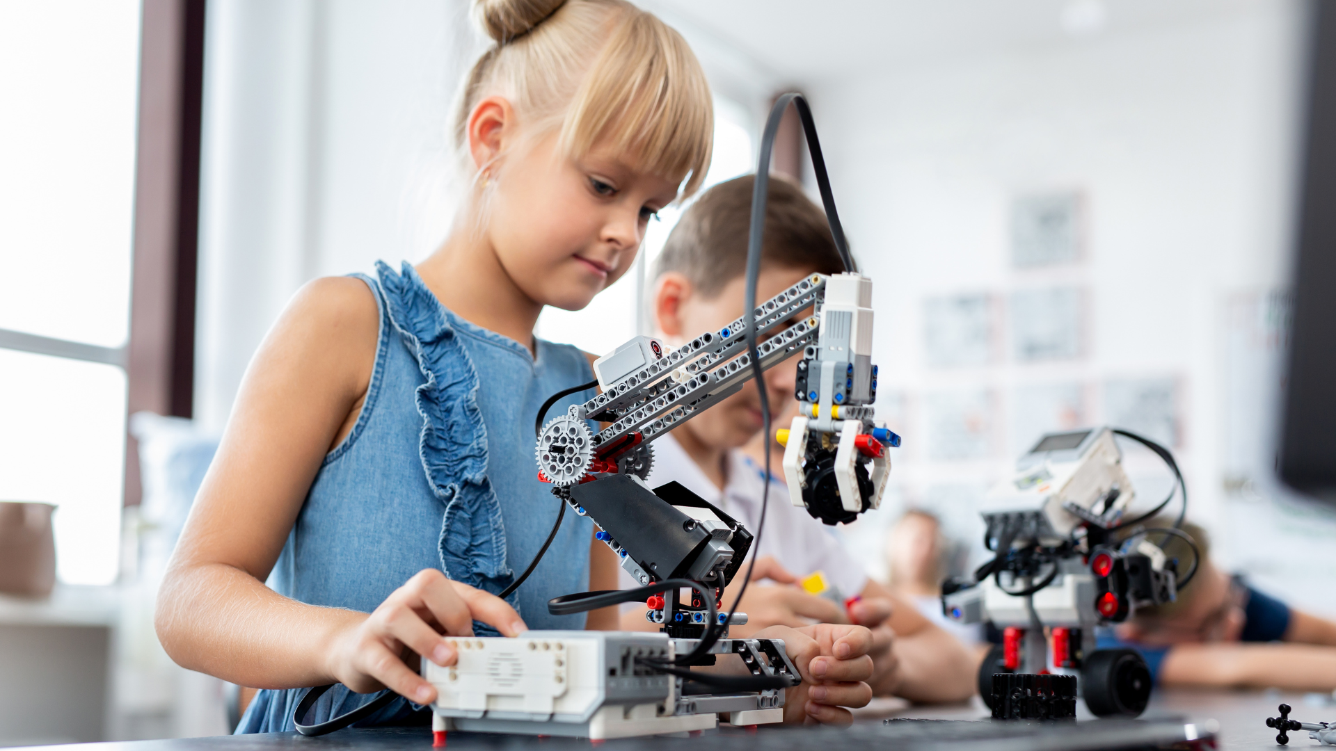 young girl demonstrating a robotics project