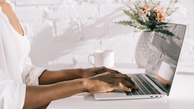 woman typing to tell the story of her neighborhood school