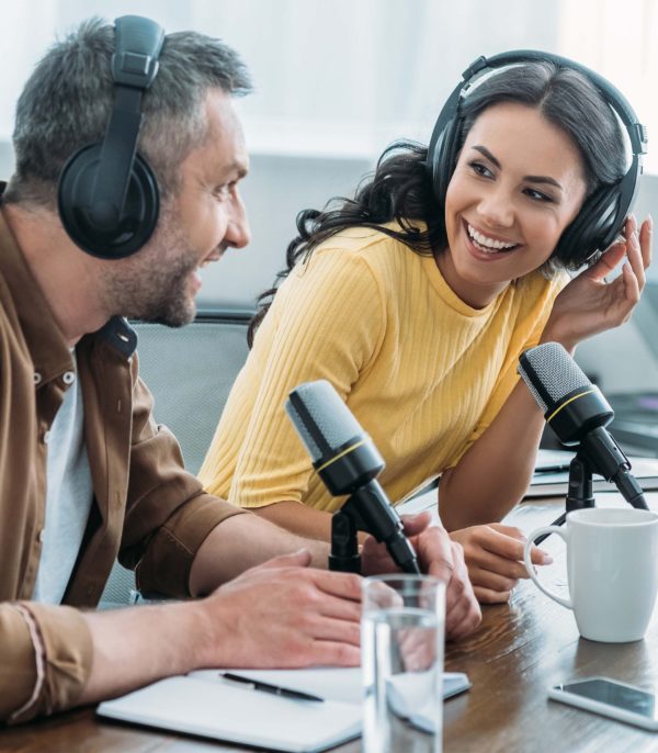 man and woman speaking on a podcast