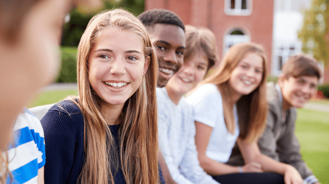 a group of students greeting a kid on a tour