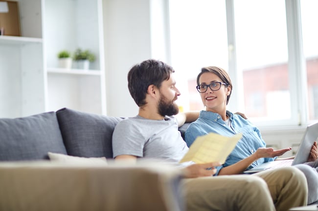 man and woman on couch discussing school