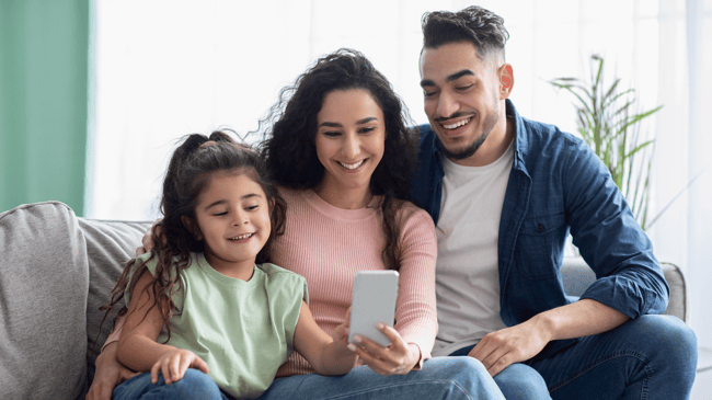 happy family looking at school social media on phone-1