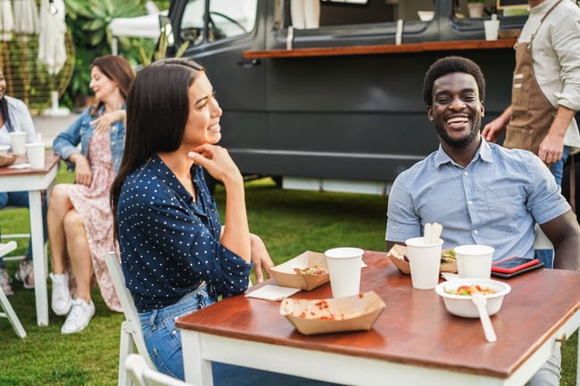 multiracial-couple-having-fun-eating-at-food-truck-2022-05-04-22-43-16-utc