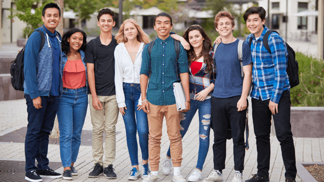 group of happy high school students standing together