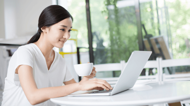 school principal working on blog at laptop