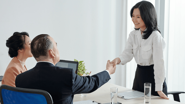 teacher candidate shaking hands with school recruiter