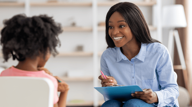 teacher sitting down with student and discussing a second chance