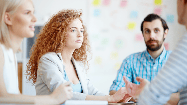 three teachers sitting at a table discussing mental health