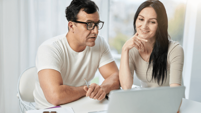 two parents looking at enrollment microsite