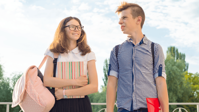 two students walking and talking on a school tour