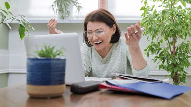 woman smiling and happy at computer