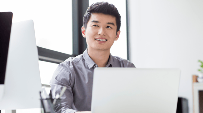 young asian man working on school social media on a laptop