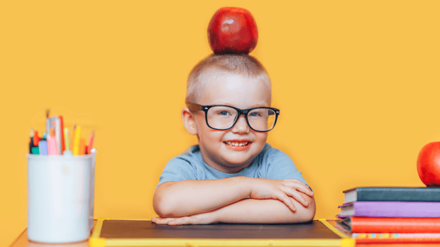 young boy taking pic at back to school photo booth