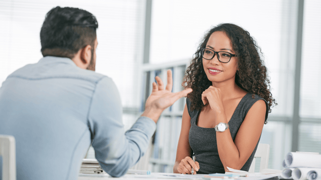 young woman talking to man during teacher interview