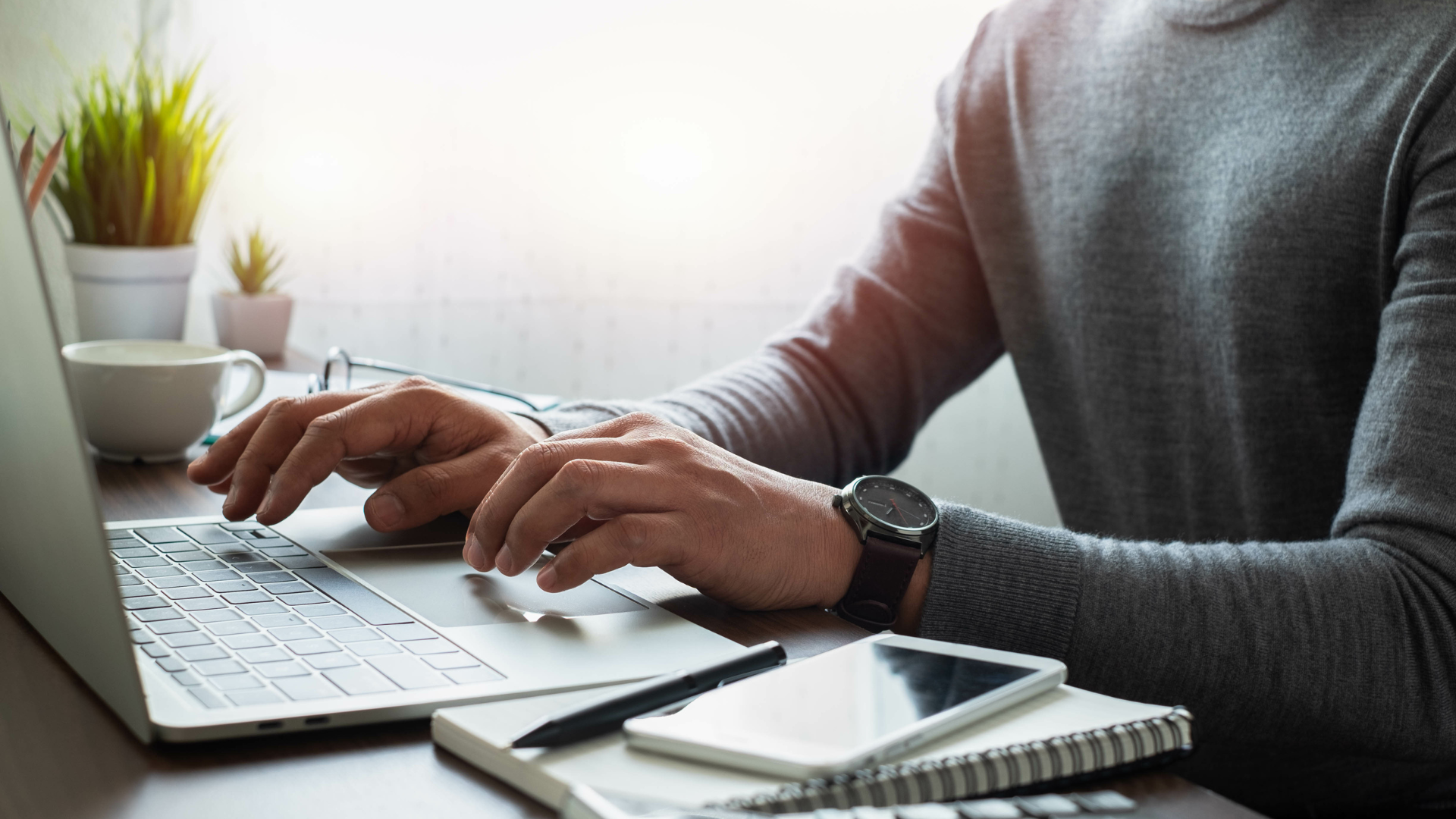 man typing at computer to build new enrollment strategy