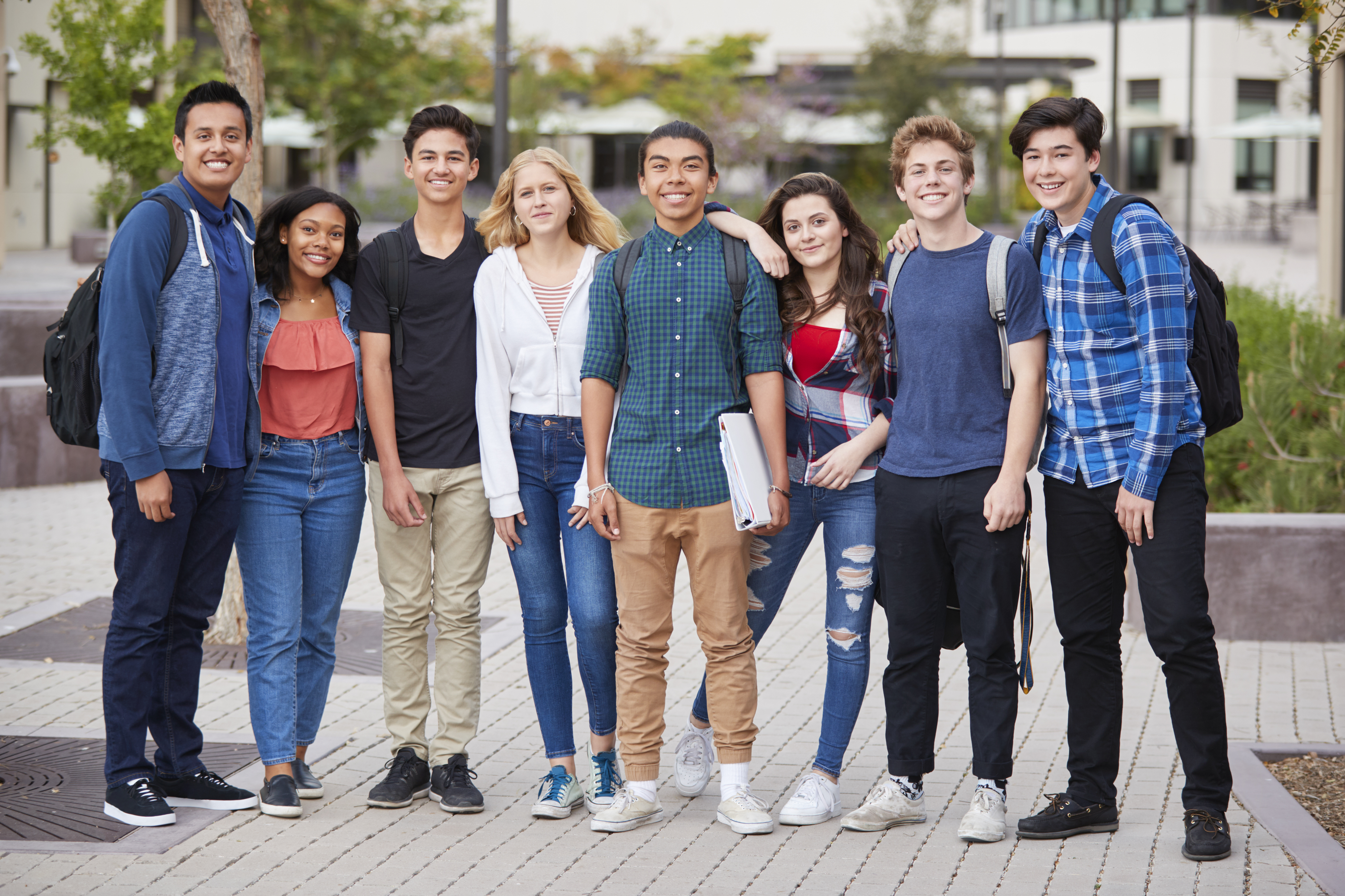 a group of high school students standing outside